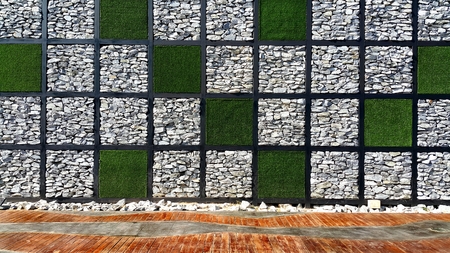 Square check pattern of grass and stone wall with wooden floorの写真素材