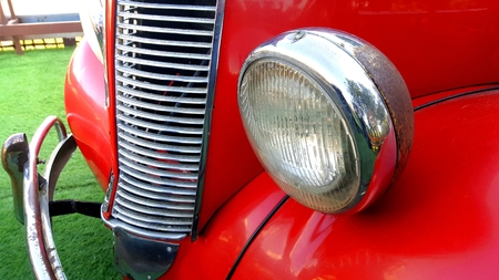 Details of the front headlight lamp red vintage classic car