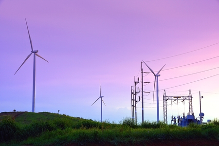 Wind turbine farm with power line and power plant during beautiful sunset, Alternative green energy for protection of nature at  Khao Kho, Phetchabun province, Thailandの写真素材