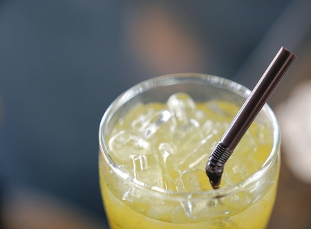 Iced herbal tea in glass with straw
