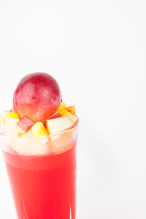 strawberry jelly with fruit salad on white paper backgroundの写真素材