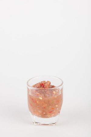 chili paste in glass on white paper backgroundの写真素材