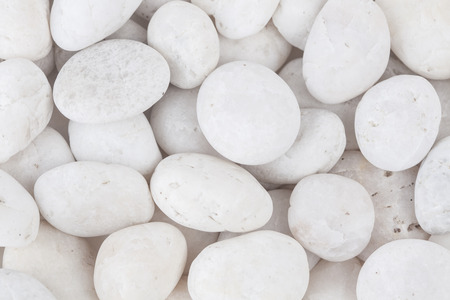 White stone on white paper backgroundの写真素材