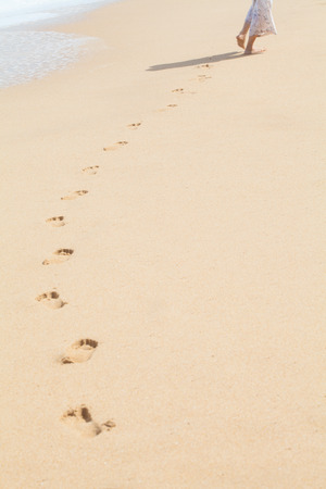 Foot prints on a sandy beachの写真素材