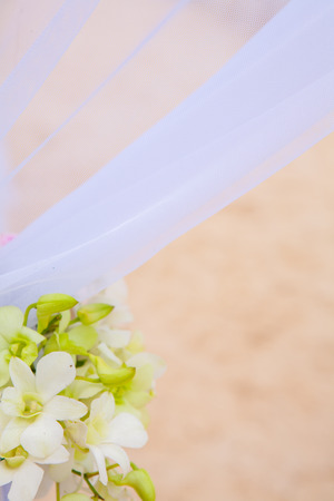 Floral arrangement at a wedding ceremony on the beach.の写真素材