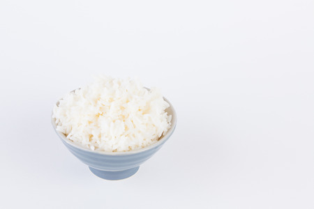 Bowl full of rice on white paper backgroundの写真素材
