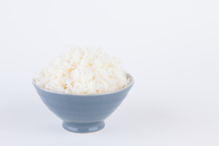 Bowl full of rice on white paper backgroundの写真素材