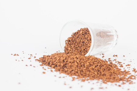Instant coffee powder in glass with white paper backgroundの写真素材