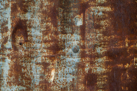 Close up of corroded iron plates and rivets on a wrecked ship. Background.