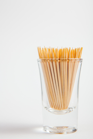 Toothpick in the glass on white paper backgroundの写真素材