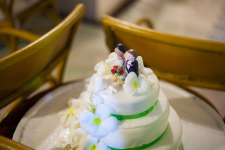 Closeup of wedding cake top bride and groom figurinesの写真素材