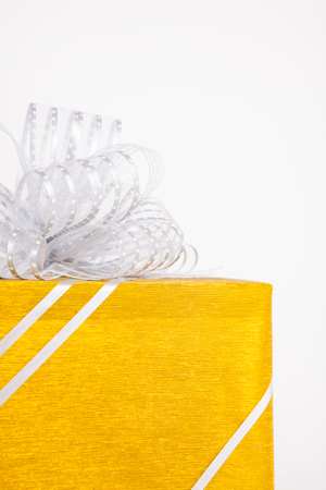Gift boxes with golden ribbon bow on white background.の写真素材