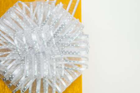 Gift boxes with silver ribbon bow on white background.の写真素材