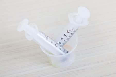 emty syrings with syrup medicine use to feed for kids on table in hospital room.の写真素材