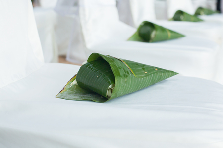 floral arrangements located on seats at a wedding ceremonyの写真素材
