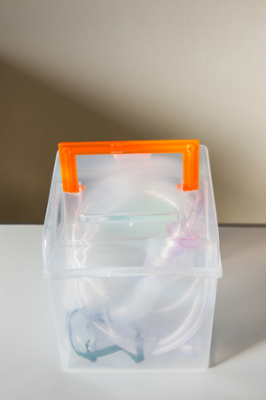 Oxygen mask box for asthma treatment on table at hospital room.の写真素材