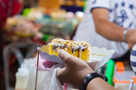 Toast is being prepared for sale in night market,Thailandの写真素材
