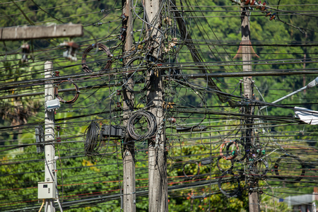 electricity cables in phuket, thailand. close up on the electricity pillar and cable intersections