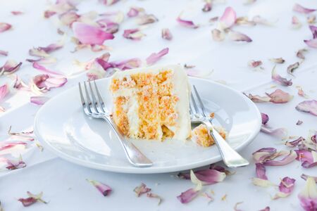 a slice of a wedding cake on dish.の写真素材