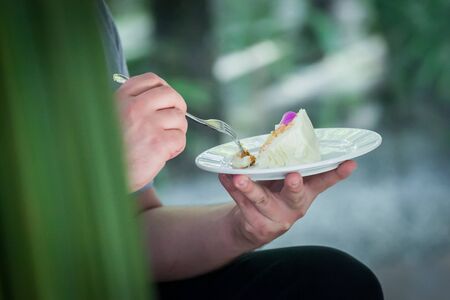 Guests attending the wedding Eat Wedding Cake with bride and groom.の写真素材