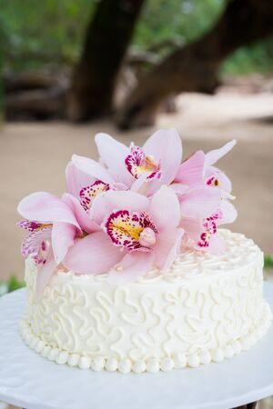Beautiful of  Wedding Cake with Flowers on Top.の写真素材