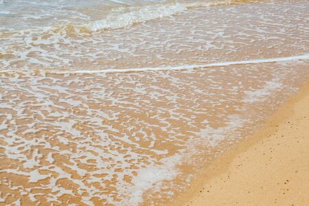 Wave of the sea on the sand beach at Thailand.の写真素材