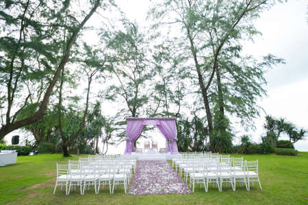 Beautiful wedding ceremony design decoration elements with arch, floral design, flowers and chairs.の写真素材
