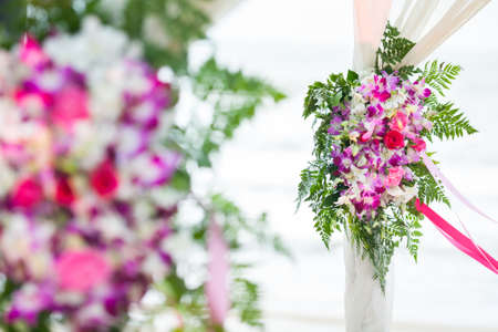 Floral arrangement at a wedding ceremony on beach.の写真素材