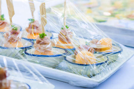 Canape ; Decoration and foods that are wrapped with plastic wrap prepared for the weddingの写真素材