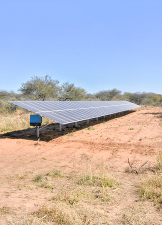 A large array of solar panels in Namibia placed in a wildlife refuge to power fences and...