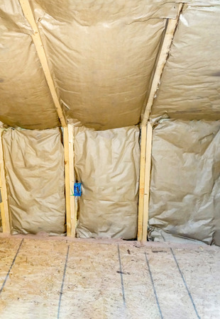 A wooden frame or skeleton used for the construction of a new building in the USA with insulation panelsの写真素材