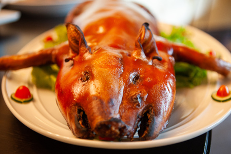 Delicious, Golden Roasted BBQ Suckling pig Cantonese Style made from a piglet that turned into Chinese delicacy which its cooked skin is very crispy and the meat is tender and juicy. Selective Focus.の写真素材