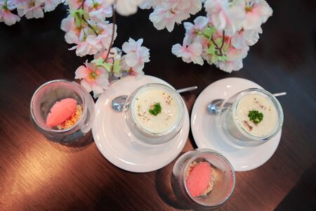 Tasty and delicious Lychee Sorbet and Spinach poached egg with sweet pastel peach and pink of Sakura or Cherry Blossom background. Good for afternoon tea or high tea party or Birthday celebration.の写真素材