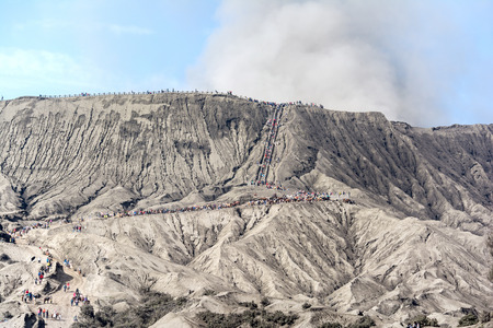 Tourist hiking and climbing steps to Mount Bromo's crater at Bromo-Tengger-Semeru National Park, a protected nature reserve since 1919.のeditorial素材