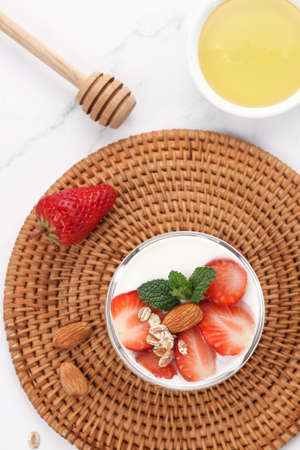 A cup of yogurt with strawberriesの写真素材