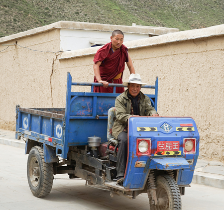 Two men riding on the tricycle in the villageのeditorial素材