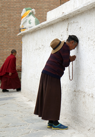 Worshiper praying at the exterior of a templeのeditorial素材