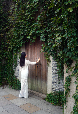 beautiful woman with traditional chinese costume at old houseの写真素材
