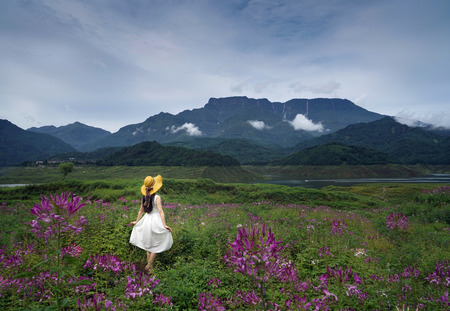 elegant woman with Wawushan mountain sceneryの写真素材