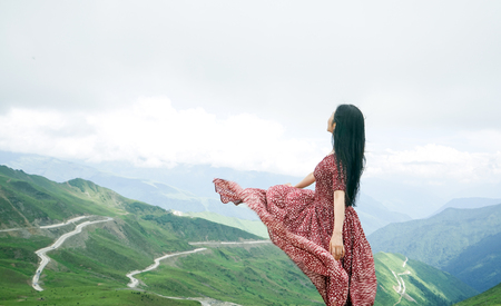 elegant woman with Jiajin Mountain sceneryの写真素材