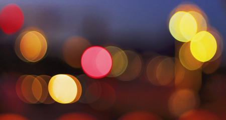 Christmas concept: Festive background with light spots and bokeh in front of a empty wooden table