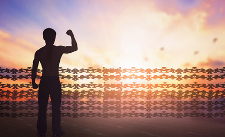 International human rights day concept: Silhouette of man raised hands Religious freedomの写真素材