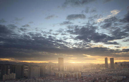 Urban real estate concept: city on twilight color sky and clouds cityscape backgroundの写真素材