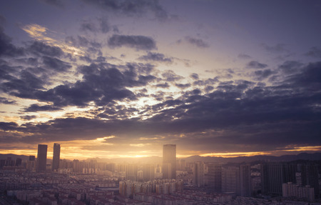 Urban real estate concept: city on twilight color sky and clouds cityscape backgroundの写真素材