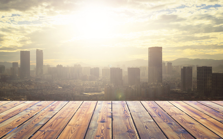 City concept: Wood table top on blur glass window wall building backgroundの写真素材