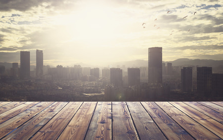 City concept: Wood table top on blur glass window wall building backgroundの写真素材