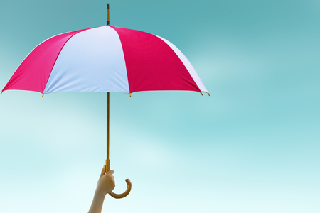 Protection concept: hand holding rainbow umbrella distinctively uniqueの写真素材