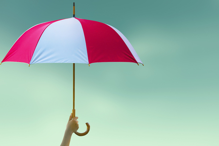 Protection concept: hand holding rainbow umbrella distinctively uniqueの写真素材