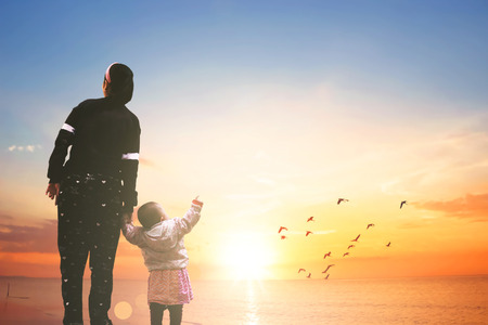 Mother's Day concept: mom and child on sunset backgroundの写真素材