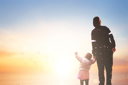 Mother's Day concept: mom and child on sunset backgroundの写真素材